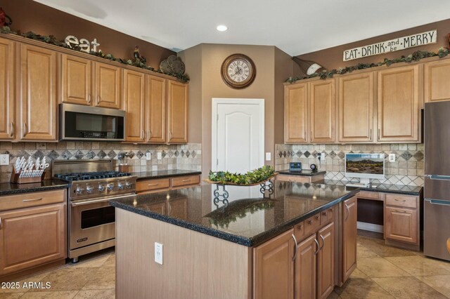 4502 E Night Owl Ln, Cave Creek, AZ 85331 - kitchen featuring dark stone counters, stainless steel appliances, a kitchen island, and decorative backsplash
