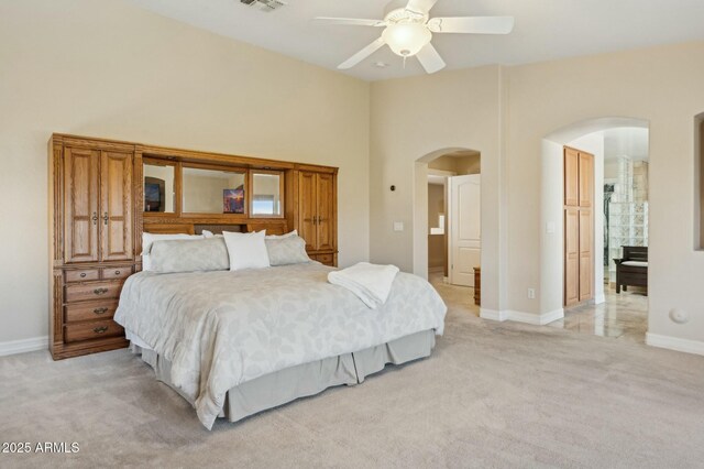 4502 E Night Owl Ln, Cave Creek, AZ 85331 - bedroom with arched walkways, light carpet, a towering ceiling, a ceiling fan, and baseboards