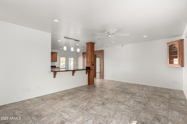 unfurnished living room with ceiling fan