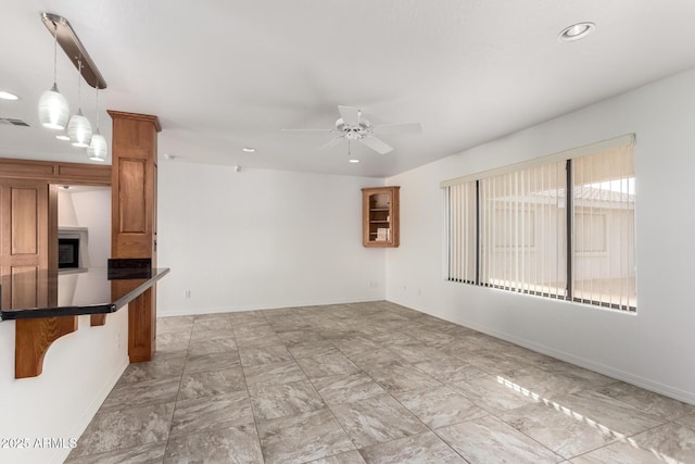 interior space with ceiling fan