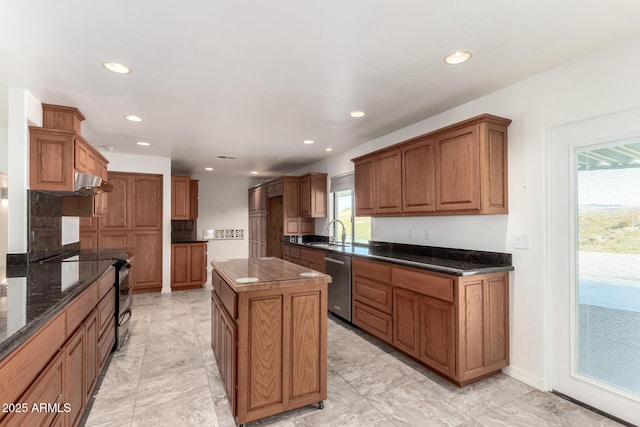 kitchen featuring dark stone counters, sink, black electric range, stainless steel dishwasher, and a kitchen island