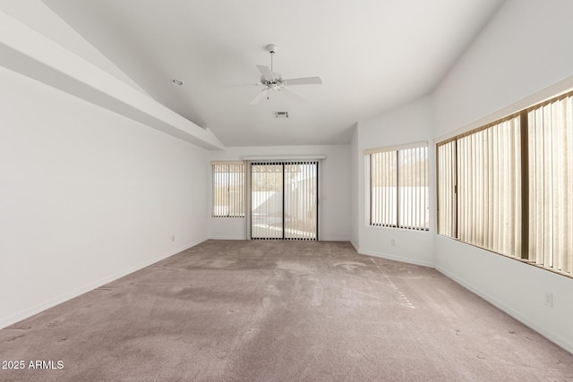 unfurnished room featuring ceiling fan, light colored carpet, and lofted ceiling