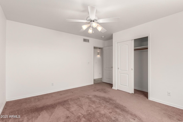 unfurnished bedroom with a closet, light colored carpet, and ceiling fan