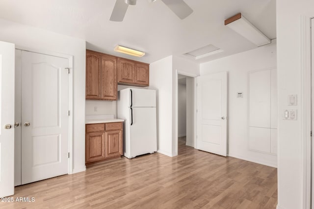 kitchen with white fridge, light hardwood / wood-style flooring, and ceiling fan