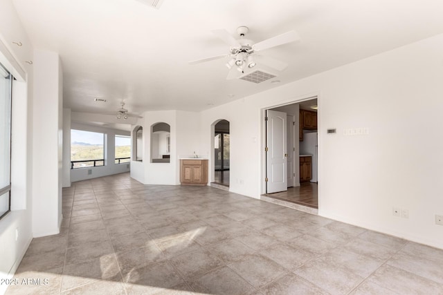 unfurnished living room with ceiling fan