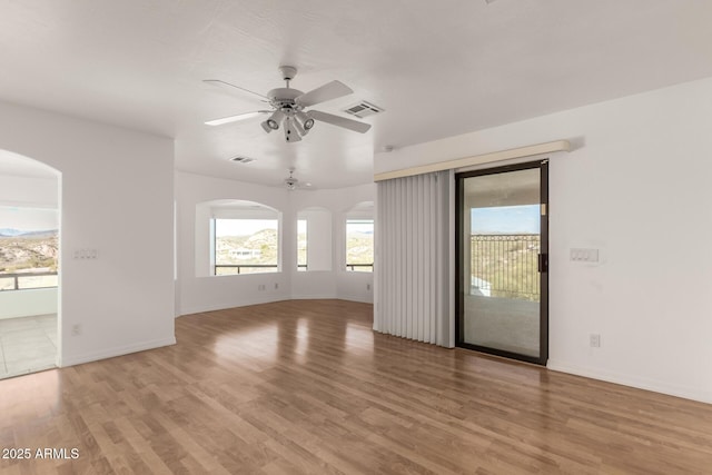 spare room with light hardwood / wood-style flooring and ceiling fan