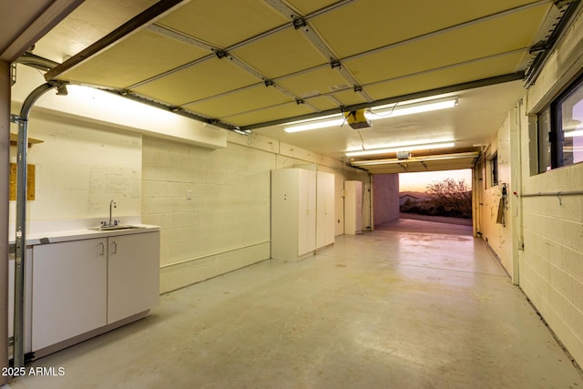 garage featuring sink and a garage door opener