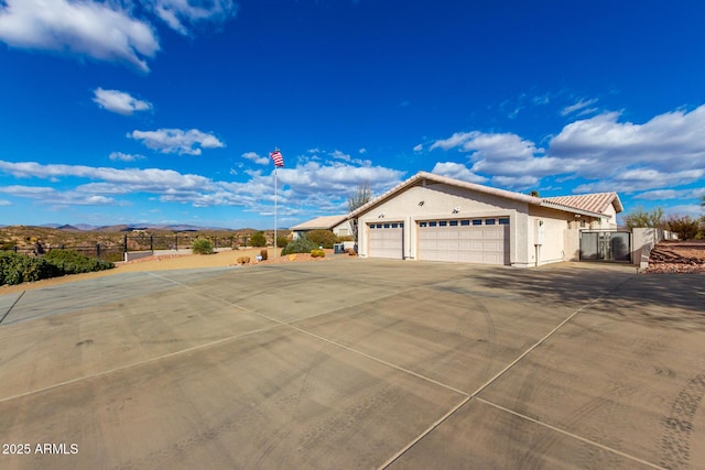 view of front of property with a mountain view and a garage