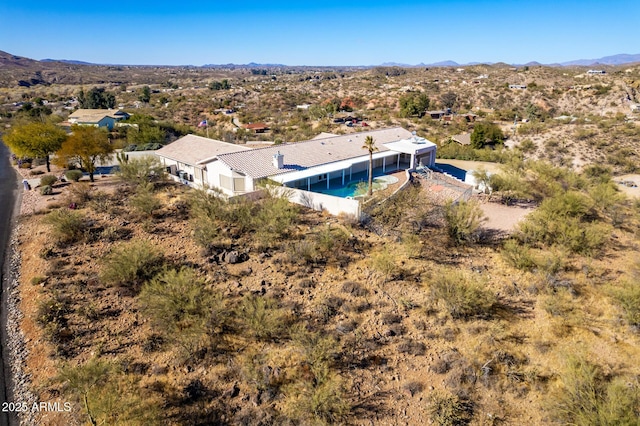 birds eye view of property with a mountain view