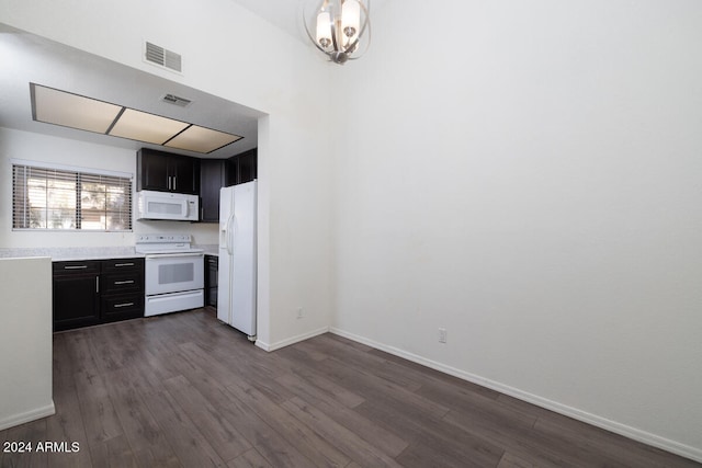 kitchen with dark hardwood / wood-style flooring and white appliances