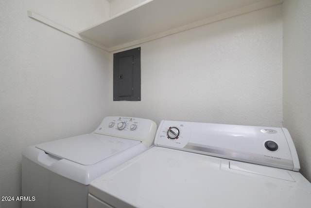 washroom featuring electric panel and washing machine and dryer