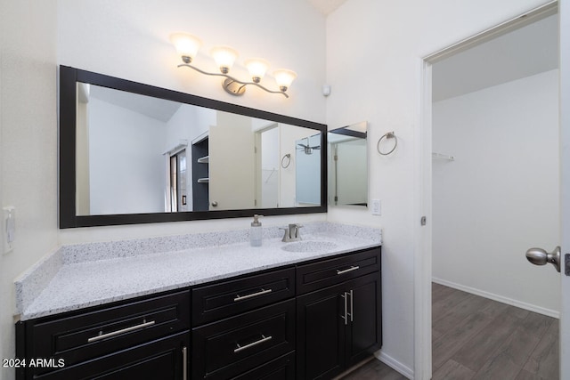 bathroom featuring hardwood / wood-style flooring and vanity