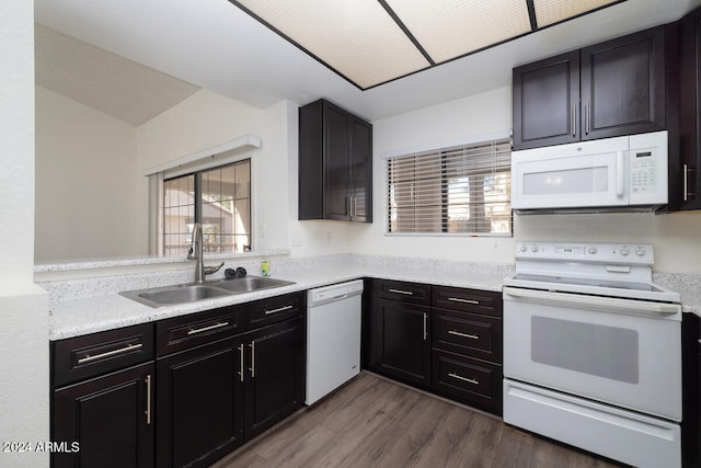 kitchen featuring sink, dark hardwood / wood-style floors, and white appliances