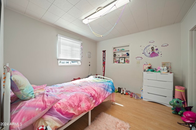 bedroom with hardwood / wood-style floors