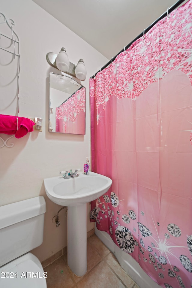 bathroom with sink, tile patterned flooring, a shower with shower curtain, and toilet