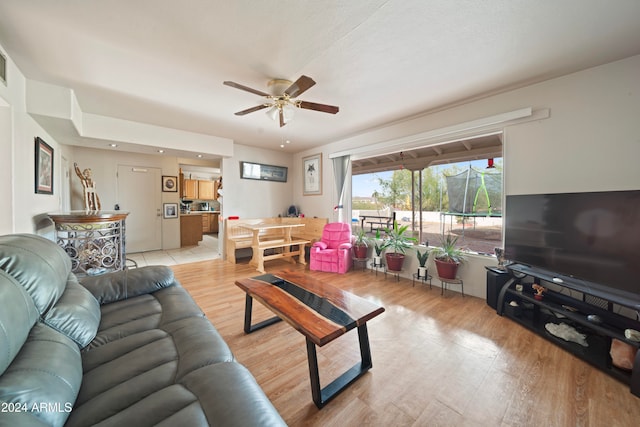 living room featuring light hardwood / wood-style flooring and ceiling fan