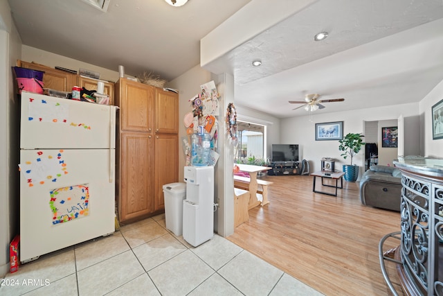 kitchen featuring ceiling fan, light hardwood / wood-style flooring, and white fridge