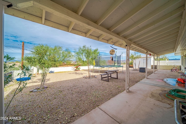 view of patio / terrace featuring a storage shed and a trampoline