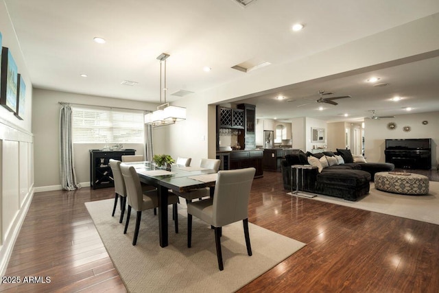 dining space with dark wood-type flooring and ceiling fan