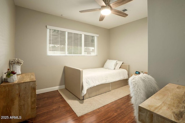 bedroom with ceiling fan and dark hardwood / wood-style flooring