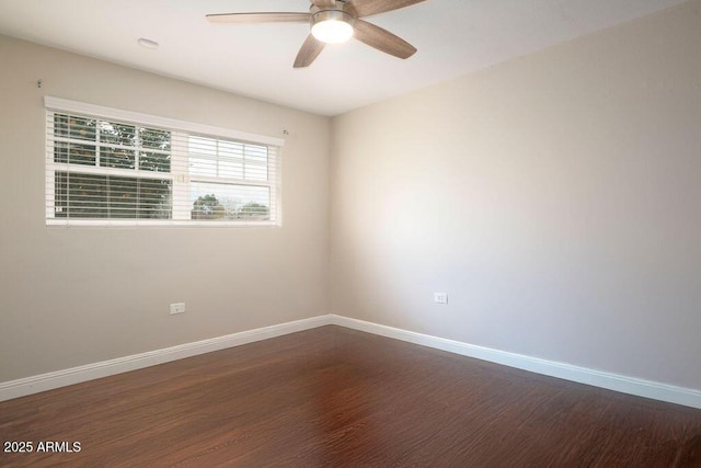 spare room featuring ceiling fan and dark hardwood / wood-style flooring