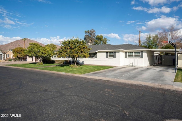 single story home with a mountain view, a front yard, and a carport