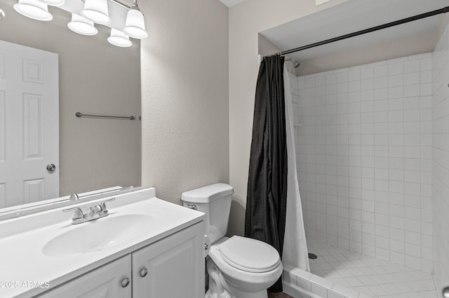 full bathroom with toilet, vanity, a textured wall, and a shower stall