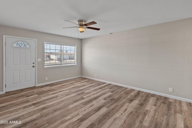 entrance foyer featuring baseboards, wood finished floors, and a ceiling fan