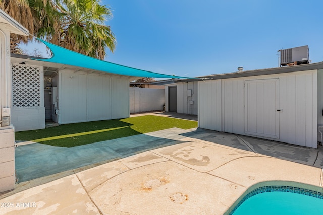 exterior space with a patio, fence, and cooling unit