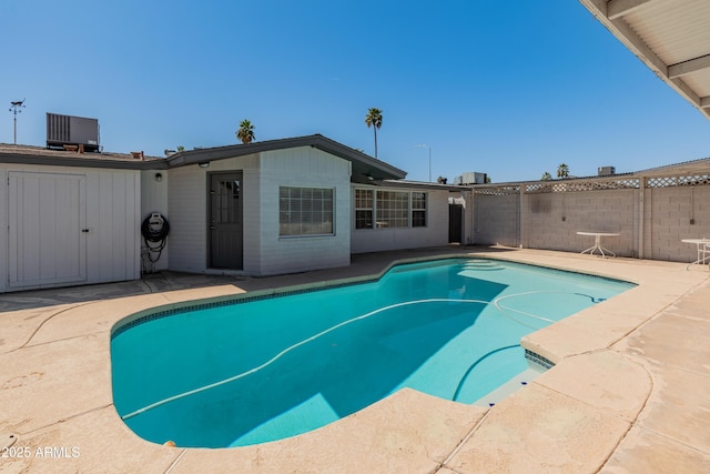 view of pool featuring a patio, fence, a fenced in pool, and central air condition unit
