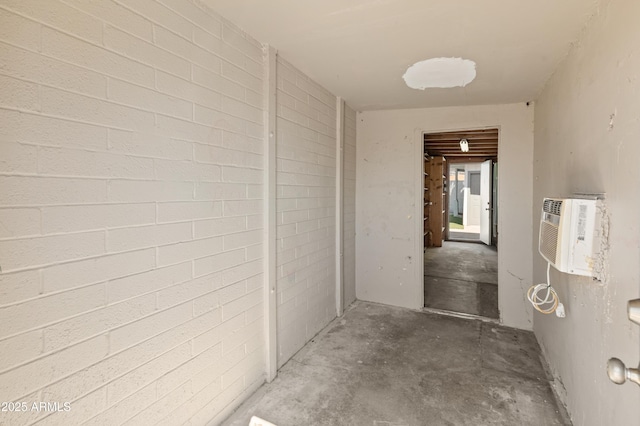 hall with unfinished concrete floors