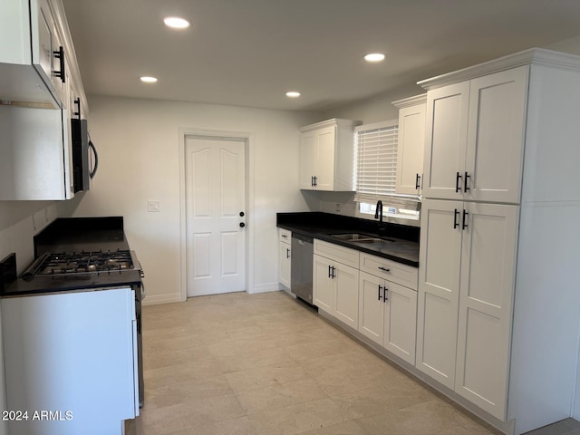 kitchen with dishwasher, white cabinetry, sink, and white range with gas cooktop