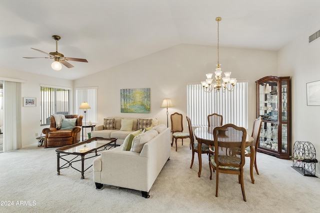 living room featuring ceiling fan with notable chandelier, light colored carpet, and vaulted ceiling