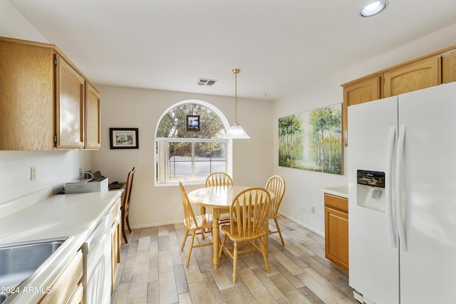 dining room with light hardwood / wood-style flooring and sink