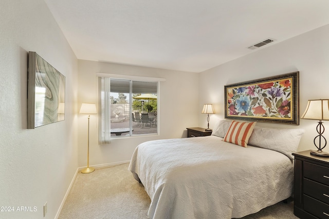 bedroom featuring light colored carpet