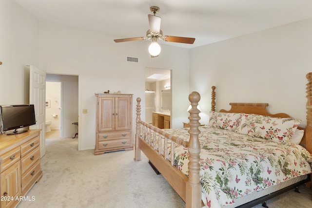 carpeted bedroom with connected bathroom and ceiling fan