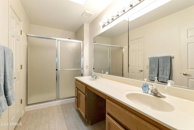 bathroom featuring vanity and an enclosed shower