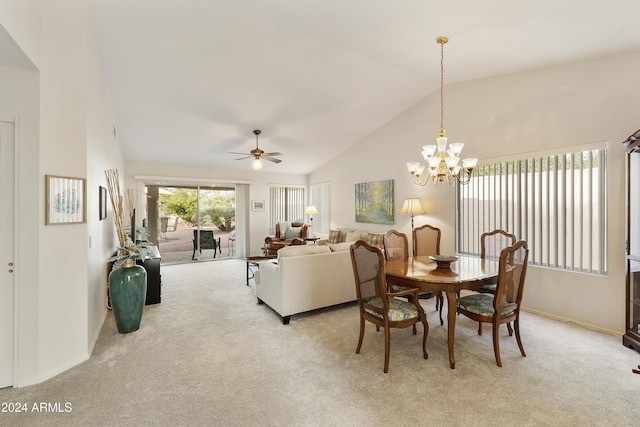 dining room featuring lofted ceiling, light carpet, and ceiling fan with notable chandelier