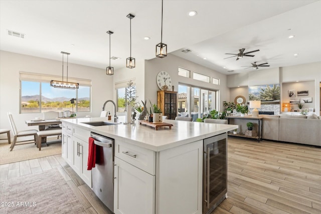 8396 E Granite Pass Rd, Scottsdale, AZ 85266 - kitchen with beverage cooler, dishwasher, white cabinetry, a ceiling fan, and healthy amount of natural light