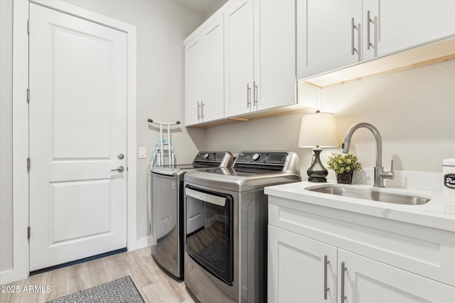 8396 E Granite Pass Rd, Scottsdale, AZ 85266 - laundry room with independent washer and dryer, cabinet space, light wood-type flooring, and baseboards