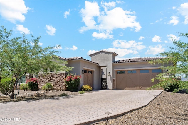 8396 E Granite Pass Rd, Scottsdale, AZ 85266 - mediterranean / spanish-style home with an attached garage, stucco siding, a tiled roof, and decorative driveway