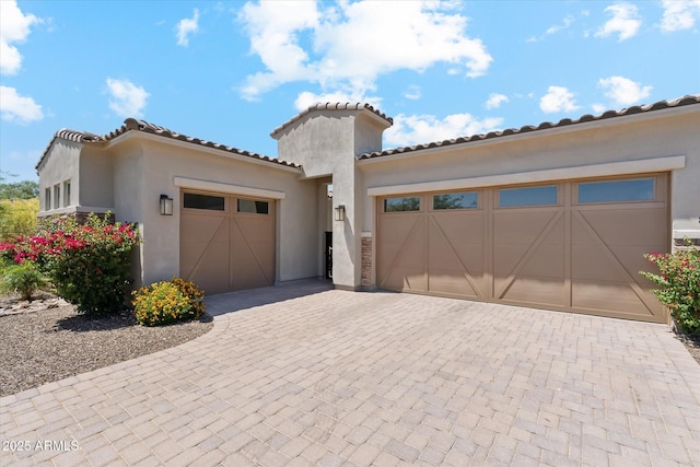 8396 E Granite Pass Rd, Scottsdale, AZ 85266 - mediterranean / spanish-style house with an attached garage, decorative driveway, stucco siding, and a tiled roof