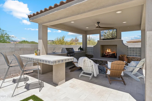 8396 E Granite Pass Rd, Scottsdale, AZ 85266 - view of patio / terrace with a warm lit fireplace and exterior bar