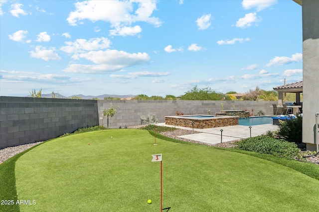 8396 E Granite Pass Rd, Scottsdale, AZ 85266 - fenced backyard featuring a putting green, a pool with connected hot tub, and a patio