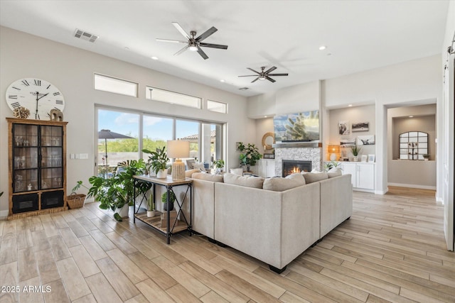8396 E Granite Pass Rd, Scottsdale, AZ 85266 - living area featuring a ceiling fan, light wood finished floors, a fireplace, recessed lighting, and baseboards