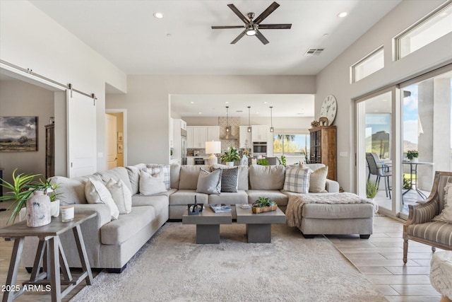 8396 E Granite Pass Rd, Scottsdale, AZ 85266 - living area featuring a barn door, ceiling fan, recessed lighting, and light wood-style flooring
