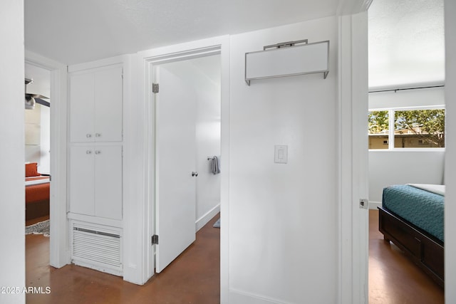 hall featuring finished concrete floors