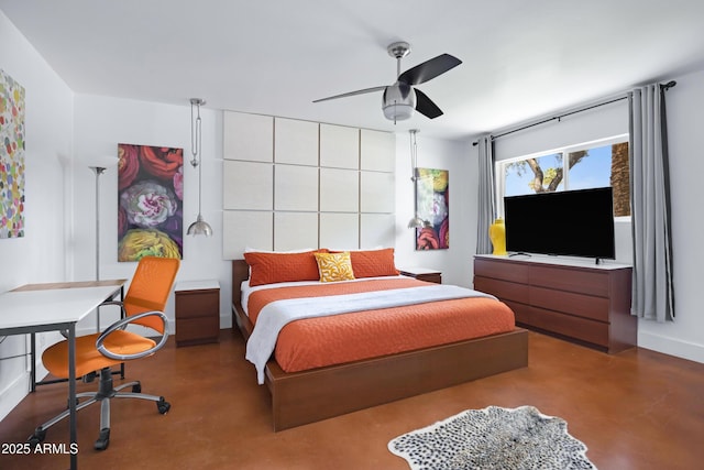 bedroom with finished concrete flooring, baseboards, and ceiling fan