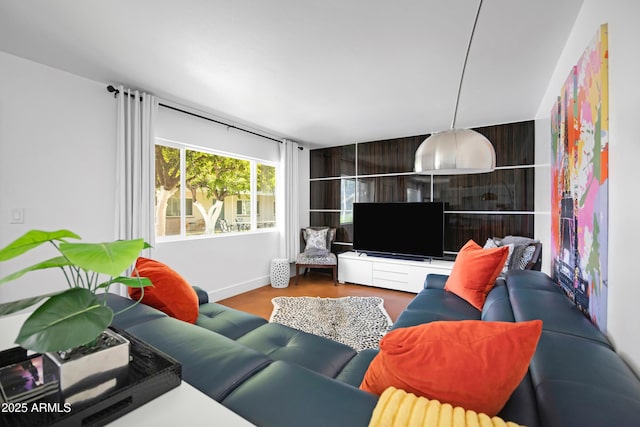 living room featuring wood finished floors and baseboards