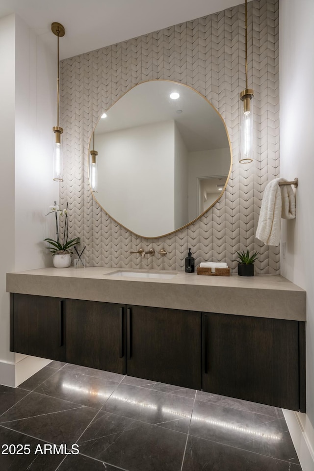 bathroom featuring vanity and decorative backsplash